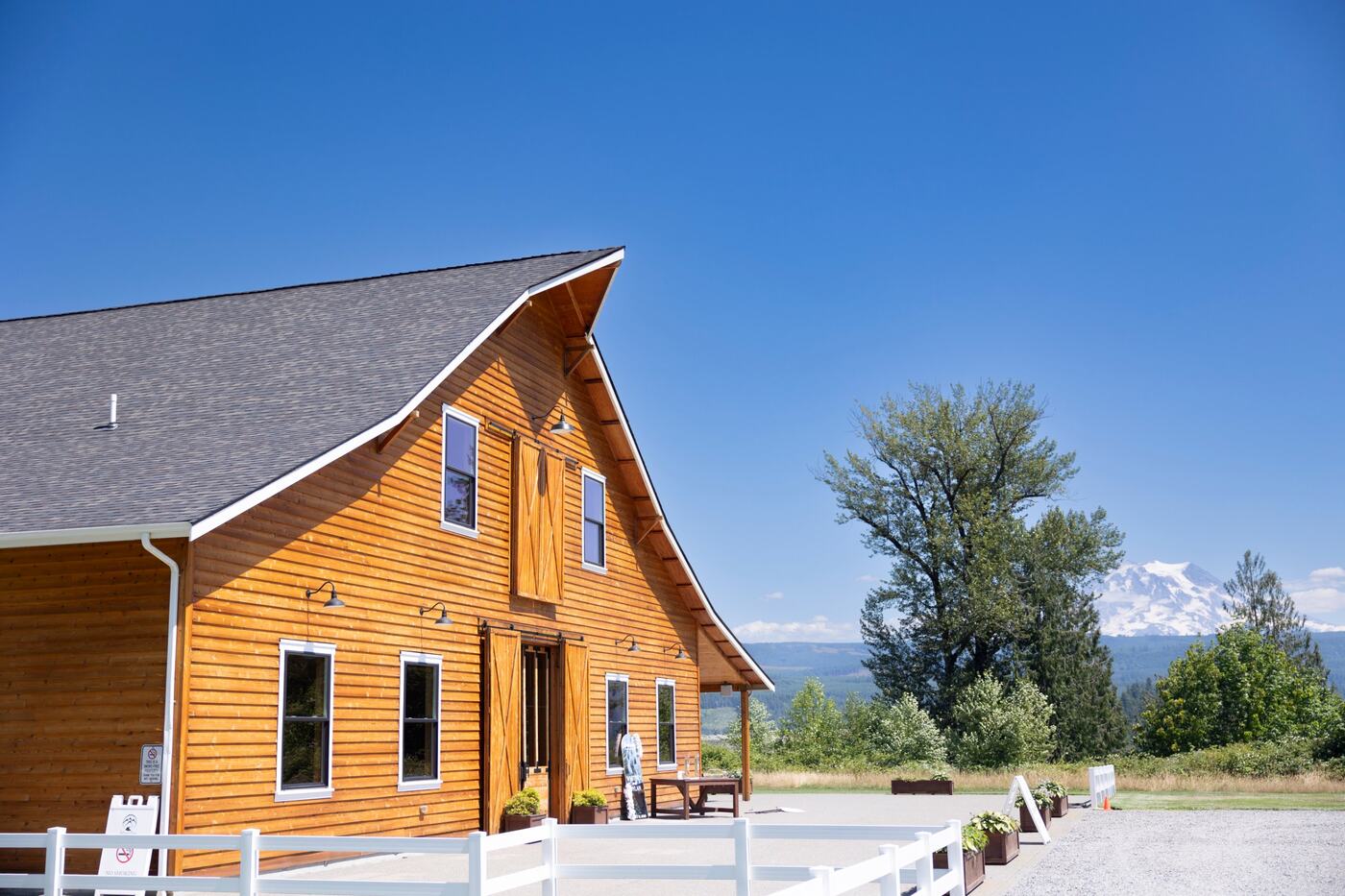 The cedar barn and white fence with Mount Rainier on a clear day