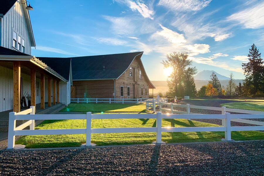 Sunrise over the bridal cottage and barn with Mount Rainier