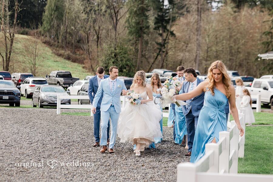 Aubrey and Casey walking with their wedding party in light blue