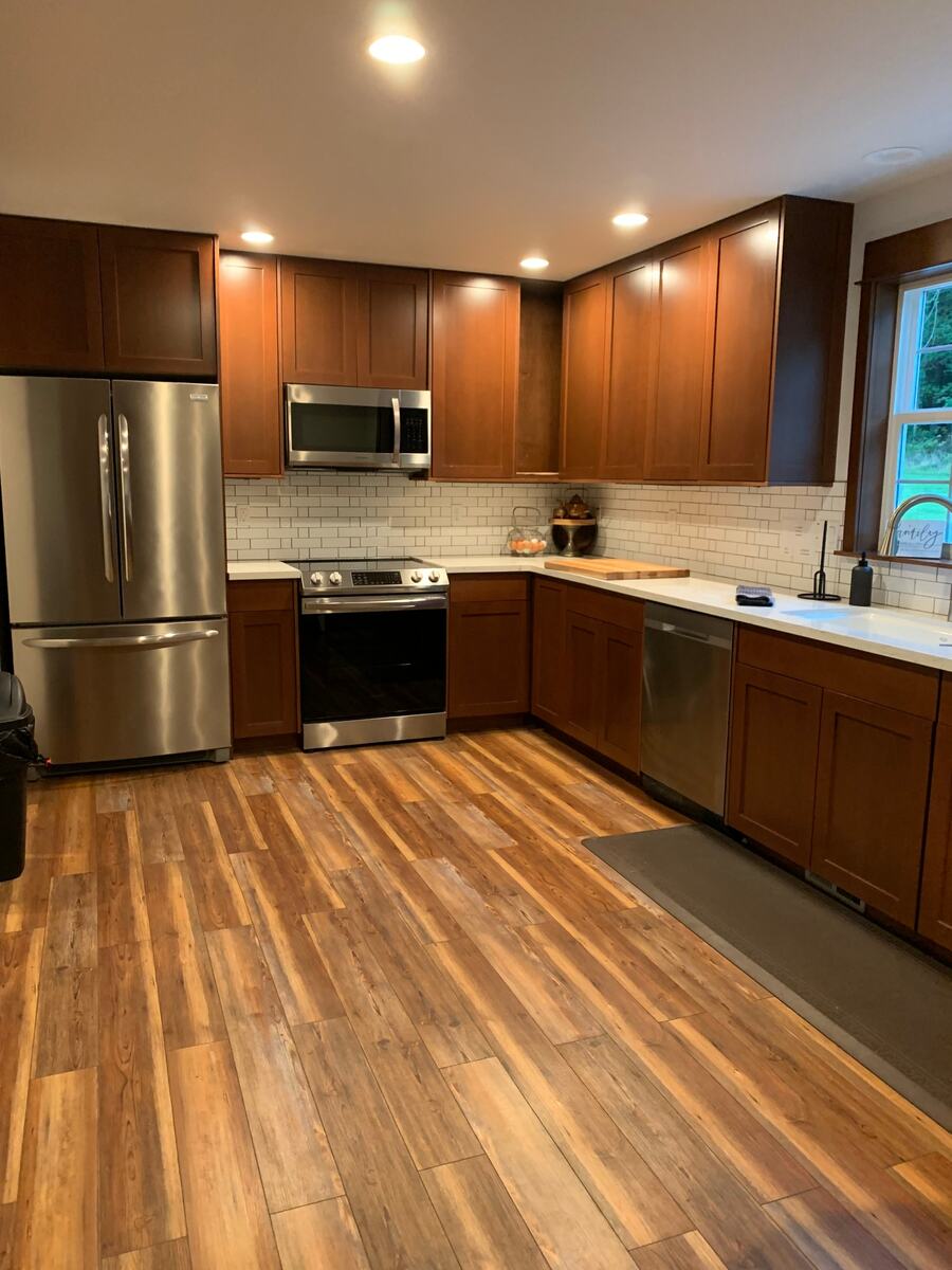 Cottage kitchen with wood cabinets, subway tile, and stainless appliances