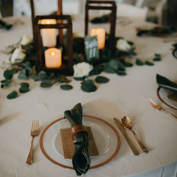 Lantern centerpiece and sage napkin place setting