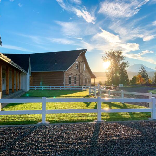 Sunrise over the cottage, barn, and Mount Rainier