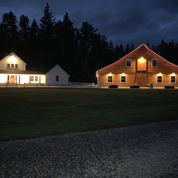 The bridal cottage and barn lit up at night