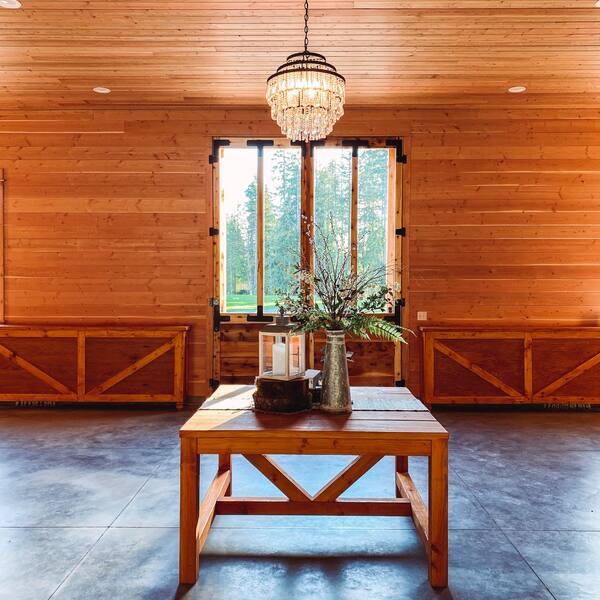 The barn foyer with the welcome table under the crystal chandelier