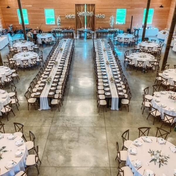 Barn reception mixing round tables with long banquet rows