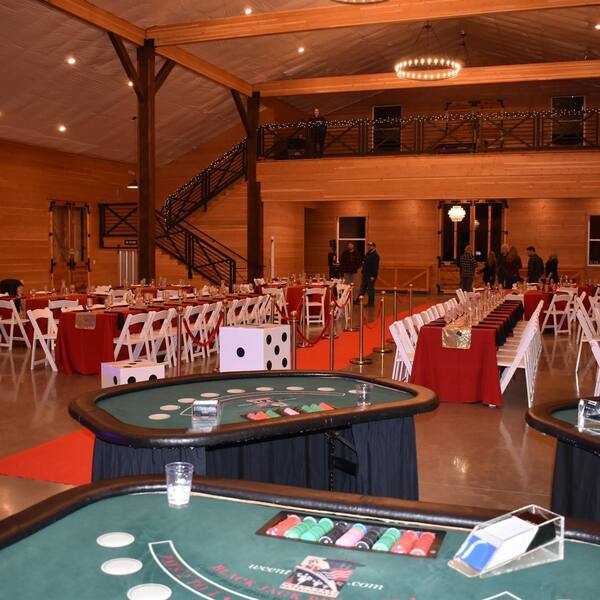 Casino-night holiday party: tables set under the loft