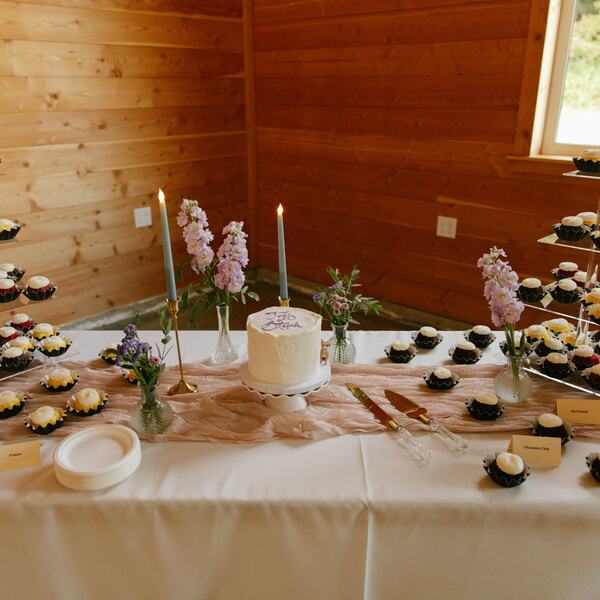 Dessert table with mini bundt cakes and a small wedding cake