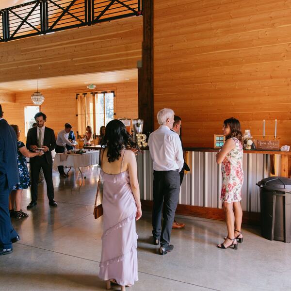 Guests at the built-in cedar bar during cocktail hour