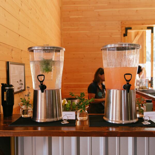 Basil water and strawberry lemonade dispensers on the bar