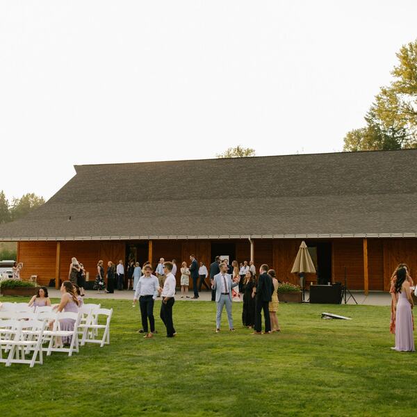 Guests on the lawn in front of the barn after the ceremony