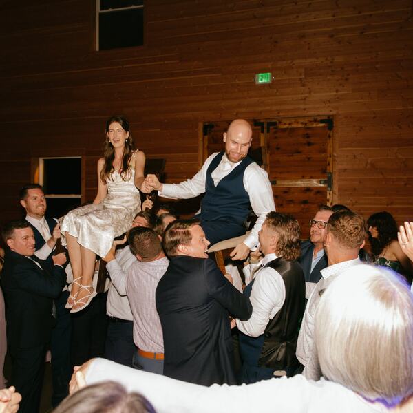 Couple lifted in chairs during the hora