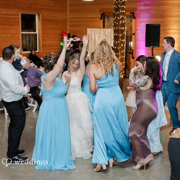Bride dancing with arms up