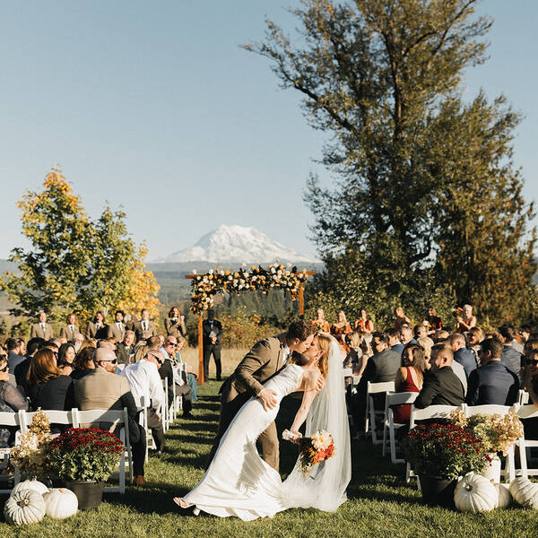 The Meadow: Fall ceremony kiss with golden trees and Rainier
