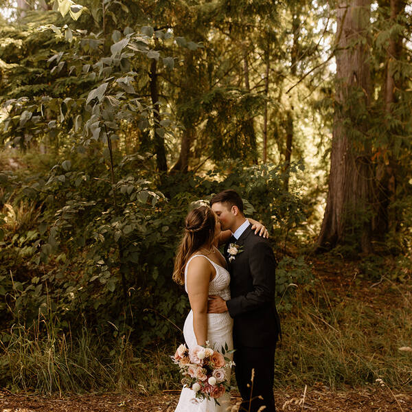 Couple kissing in the sunlit woods