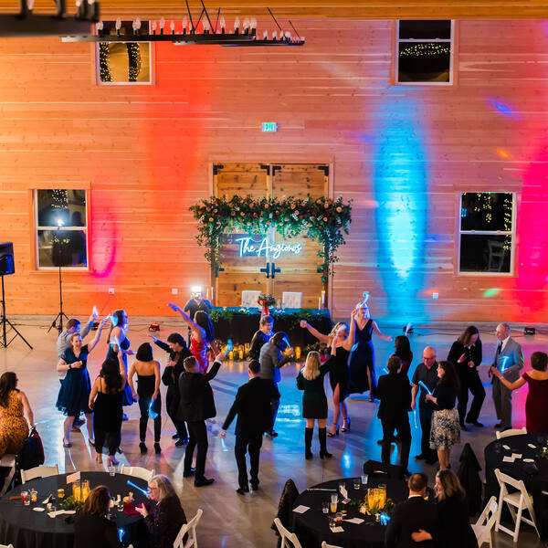 Packed dance floor under colored lights at night
