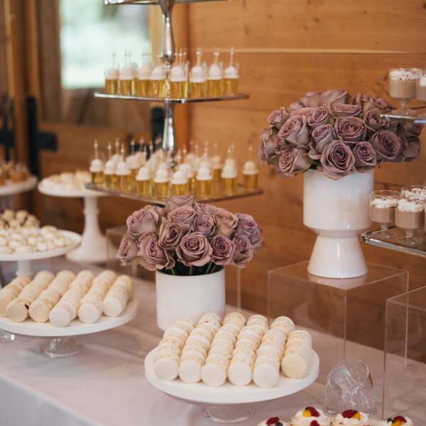 Dessert table with lavender roses against the cedar wall