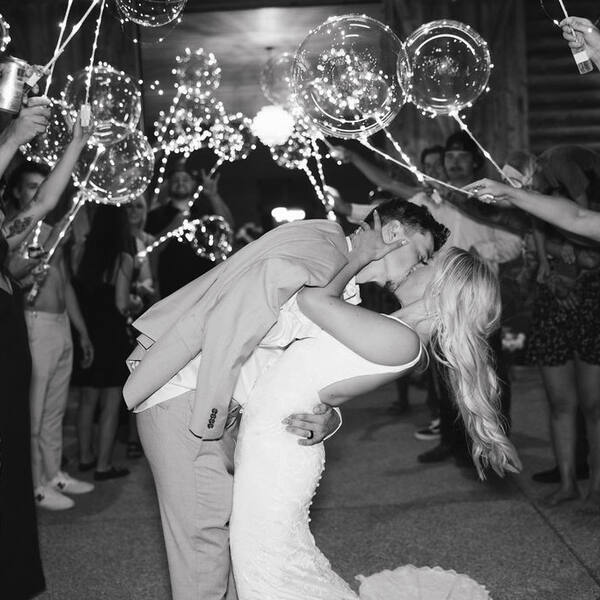 Dip and kiss under glowing light-up balloons at the send-off