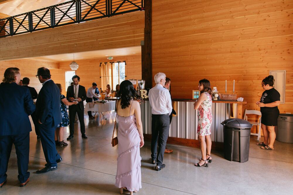 Guests gathered at the built-in cedar and corrugated-metal bar during cocktail hour