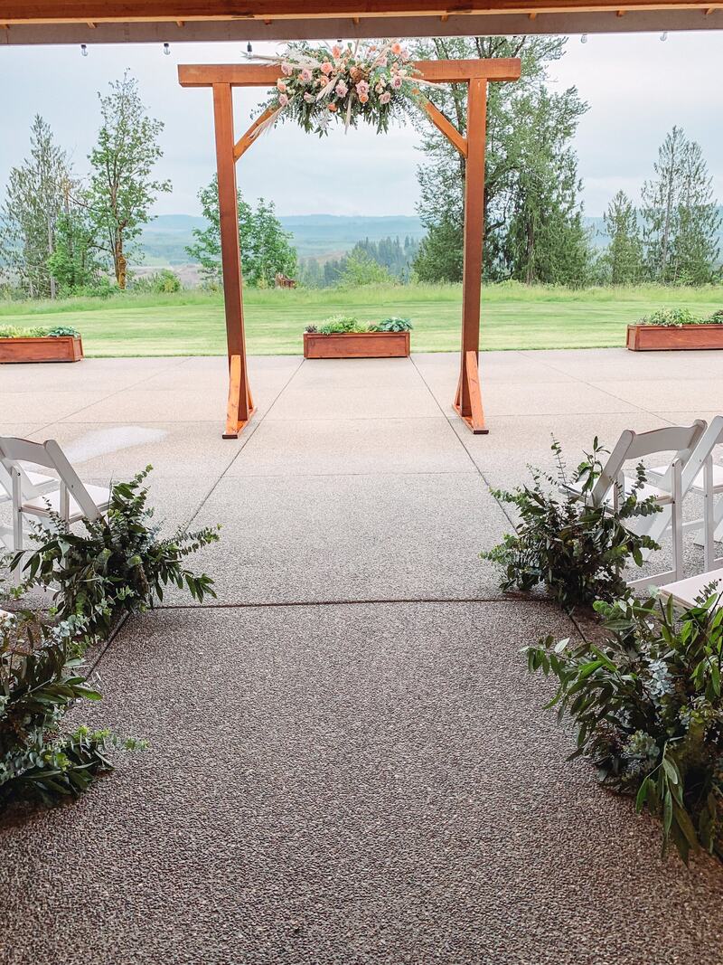 Aisle under the covered patio leading out to the arbor