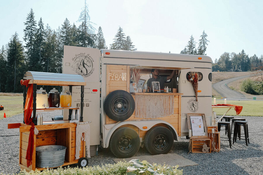 Vintage horse-trailer mobile bar set up on the gravel drive