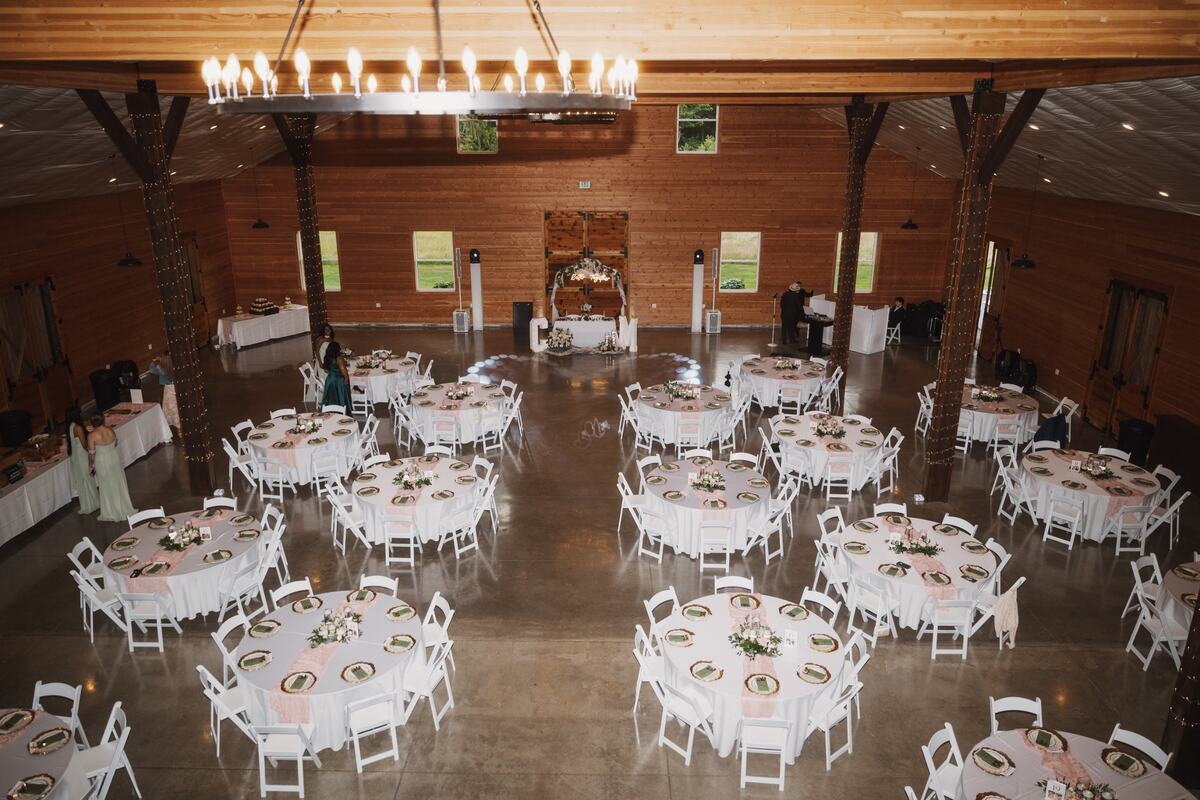 Overhead view of the barn set with round tables, a sweetheart table, and the dance floor
