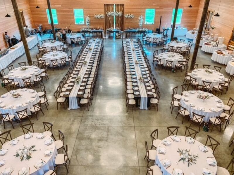 Barn reception mixing round tables with two long banquet rows